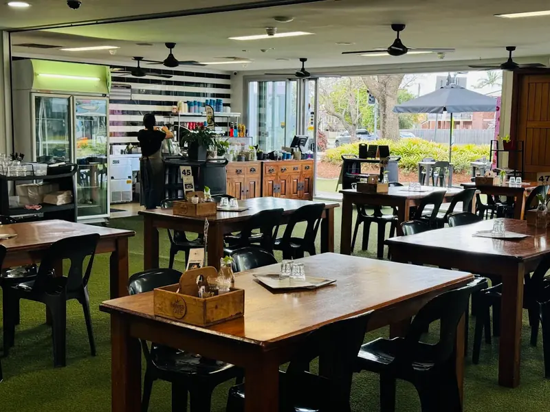 Shaded alfresco dining area at MK Bower Cafe garden, Stones Corner